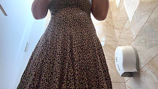 A horny mature MILF is very aroused and is rubbing her pussy in the public restroom at the office.