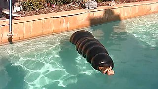 Julia in an inflatable latex cocoon in pool