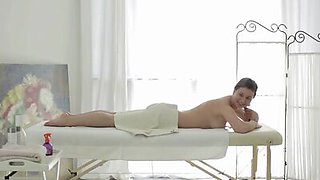 The masseuse gets ready to work on Maia's young body before they try anal