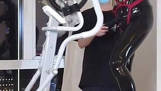 Mz27 - a Girl Bound in Latex Walks on a Treadmill