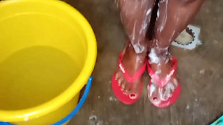Getting a bath in traditional bathroom in village.