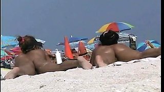 Amazing beach voyeur vid of two nudist girls and their wet pussies