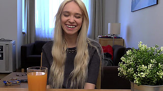 Blonde Babe Grips Purple Vibrator with Naughty Smile