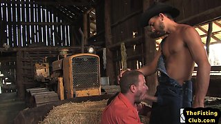 Fisting cowboy fucks bottom with fist on hay in stable