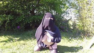 Muslim in burqa and stockings – flashing outdoors