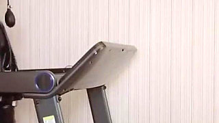 Mz24 - a Girl Bound to a Treadmill with Metal Restraints and Shackles