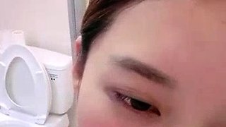 Asian babe sucking and jerking two hard dicks